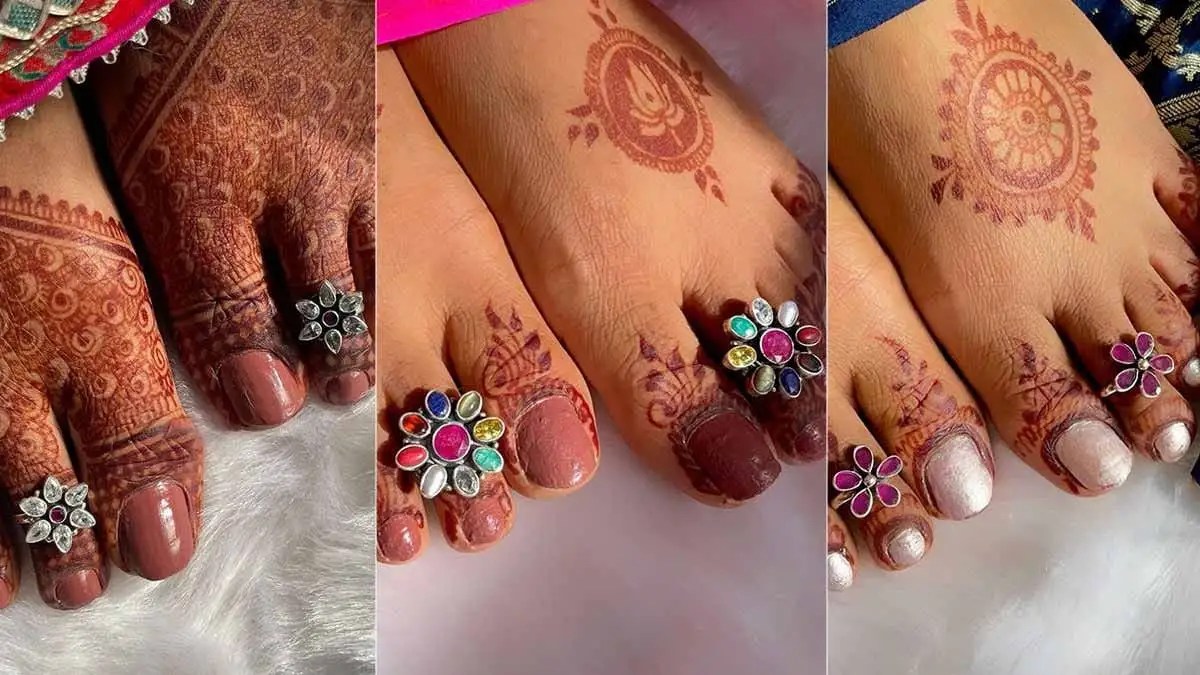 Decorative toe rings with mehndi on feet.