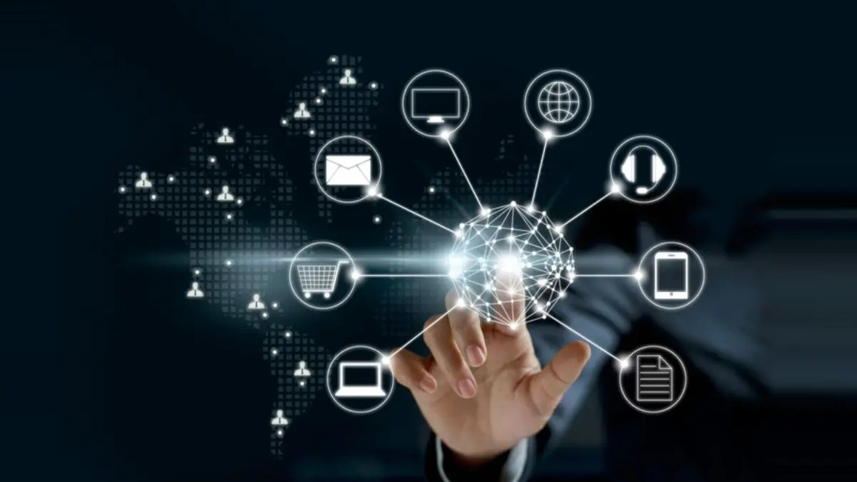 Hand touching digital network icons.