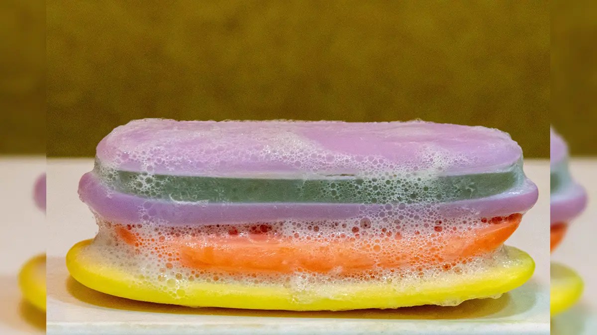Colorful leftover soap bars stacked together with foam – creative soap hacks for home use.