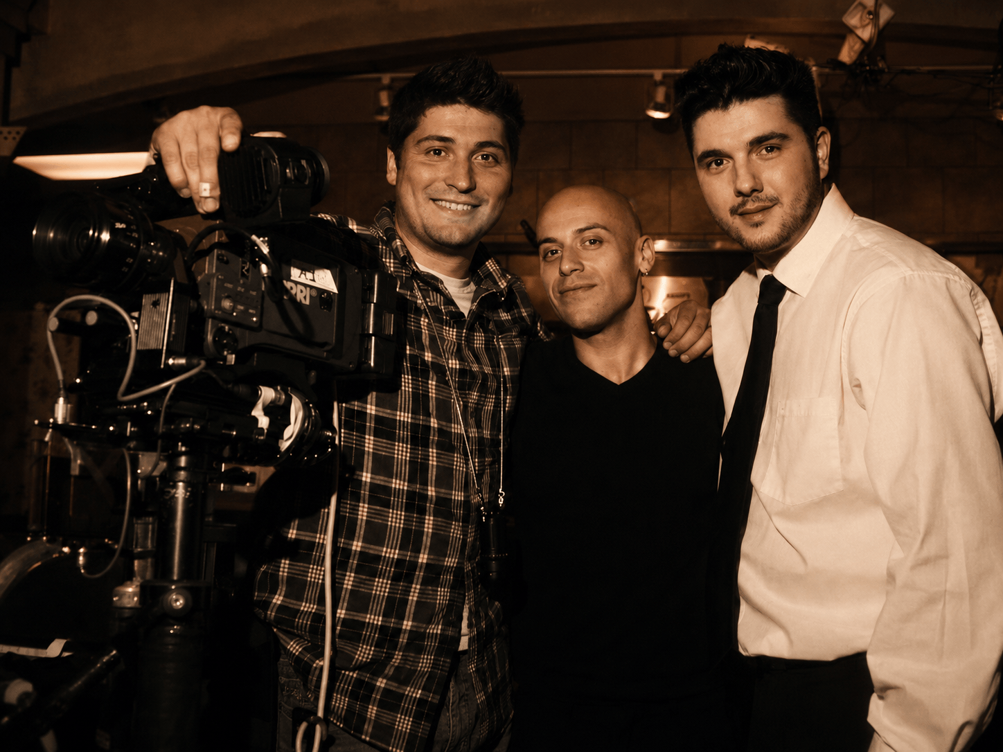 Alistor Grimsby, a cinematographer, and a short film actor stand inside a restaurant beside an ARRI Alexa cinema camera.