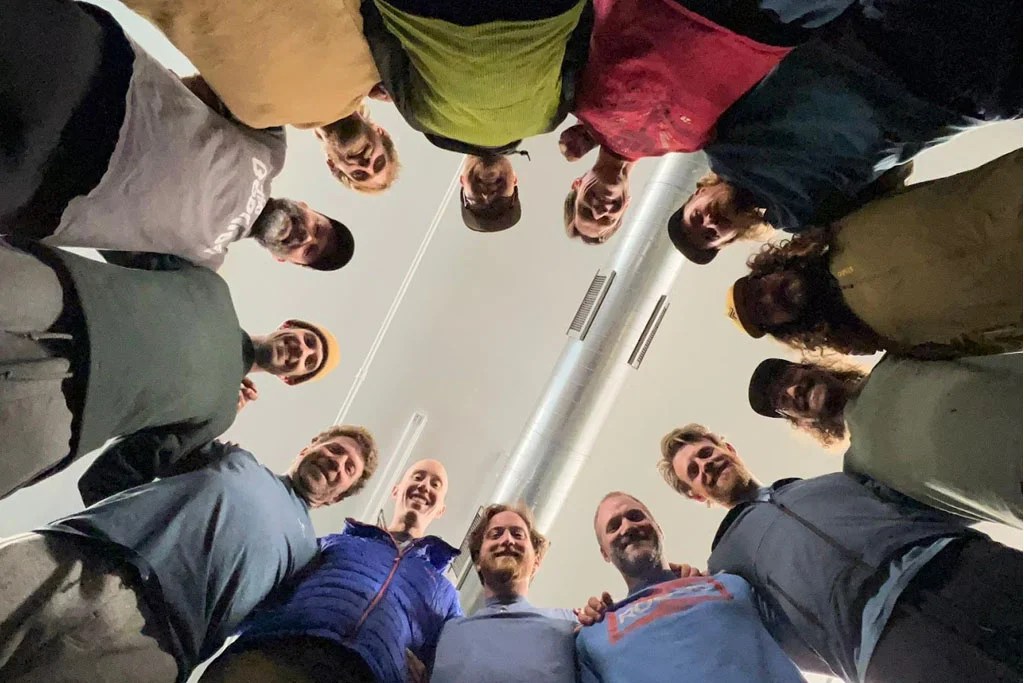 A diverse group of men sitting together in a supportive circle, sharing stories and connecting emotionally in a safe environment.