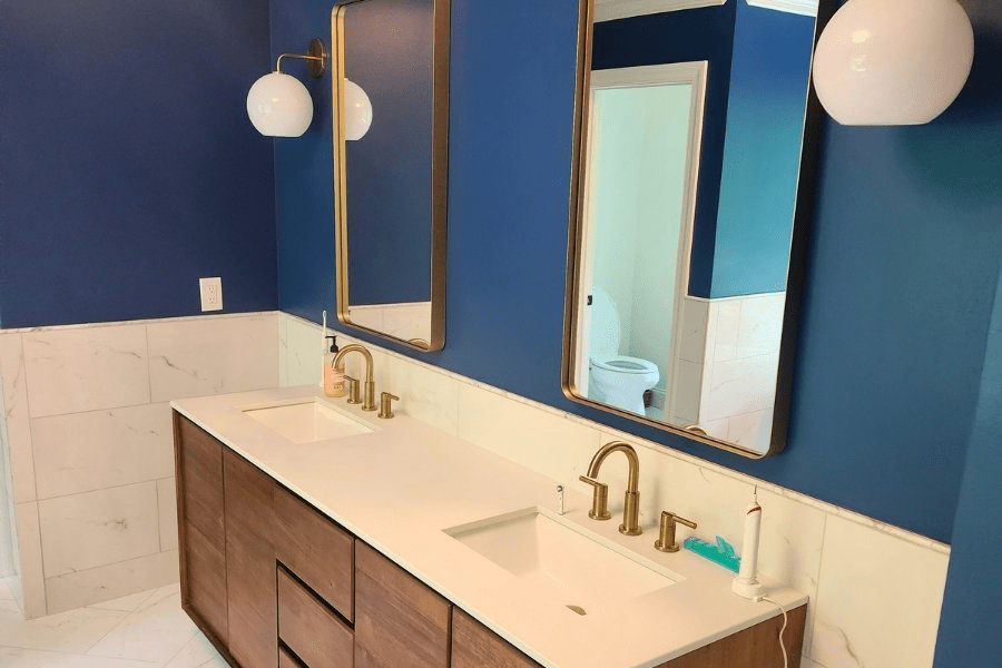 Bathroom With Double Vanity And Blue Walls