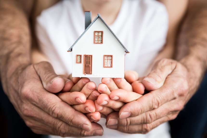 Family holding house in hands
