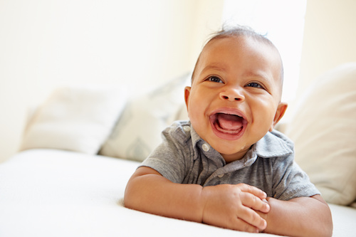 laughing baby boy on stomach