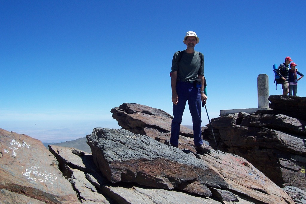 Hiker on mountain summit in Spain