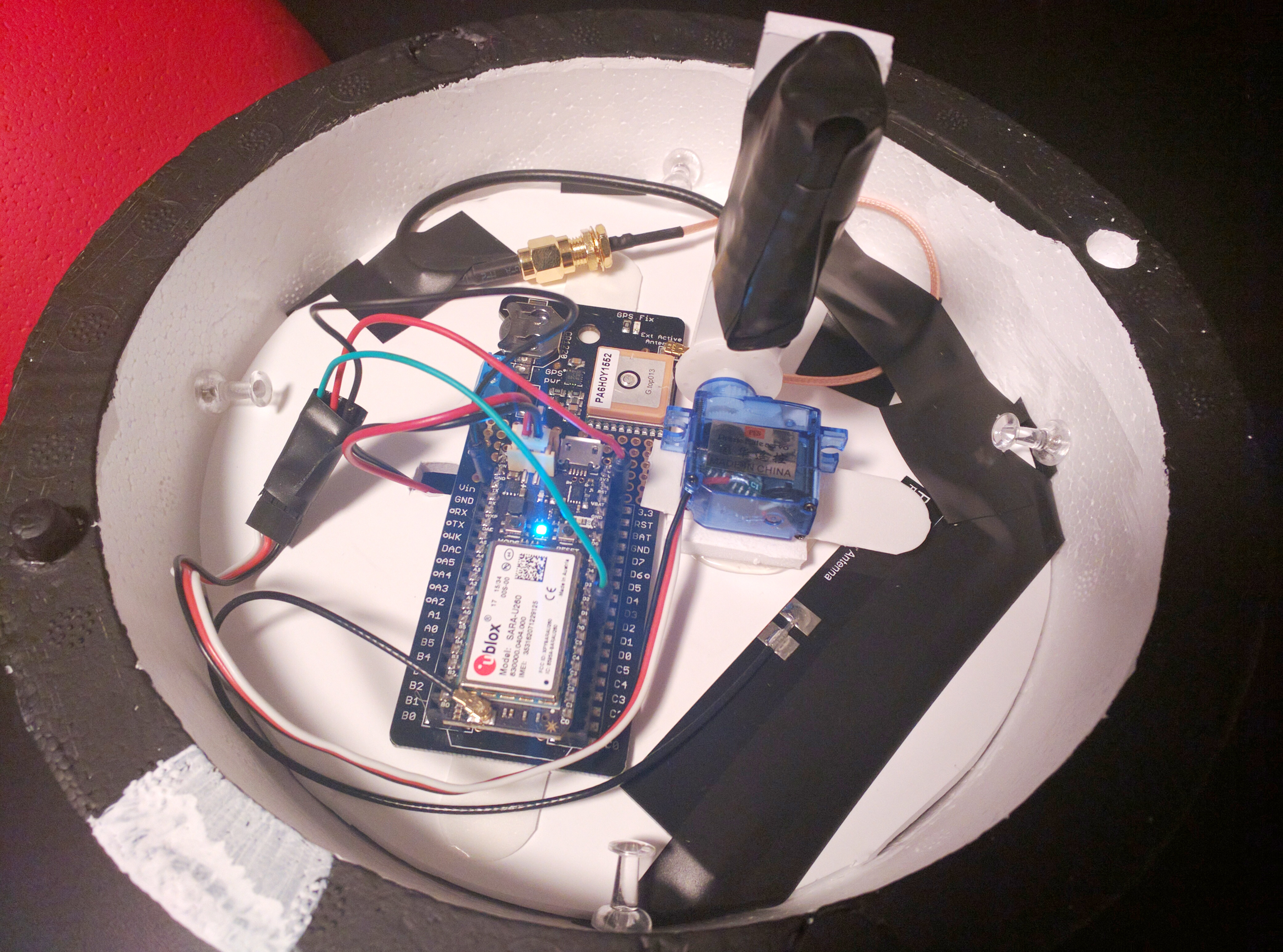 Inside of the sphere sits a Particle Electron, tracker and servo