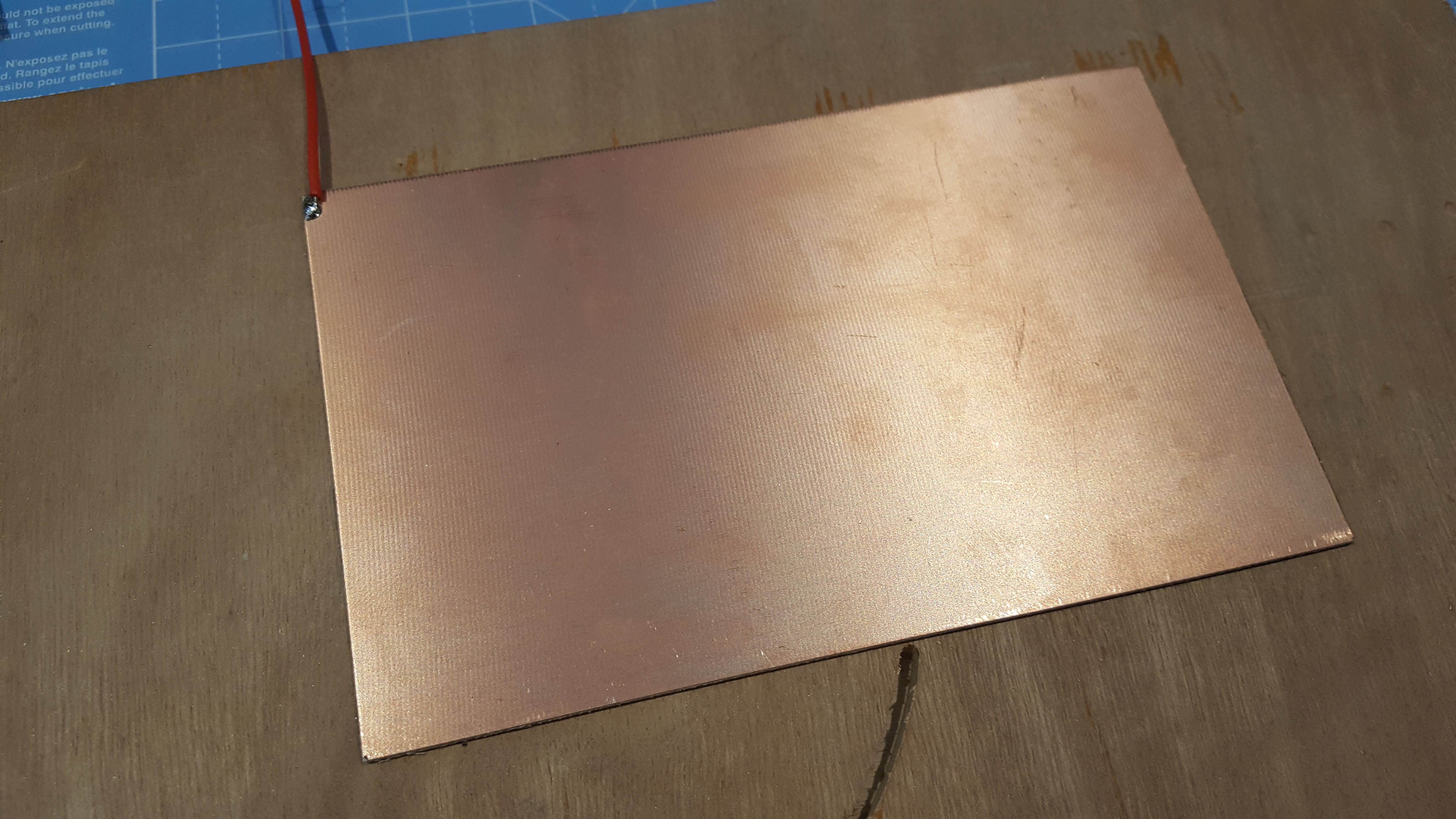 Copper clad secured to wood
