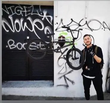 An image of a man next to a bike on a wallhanger