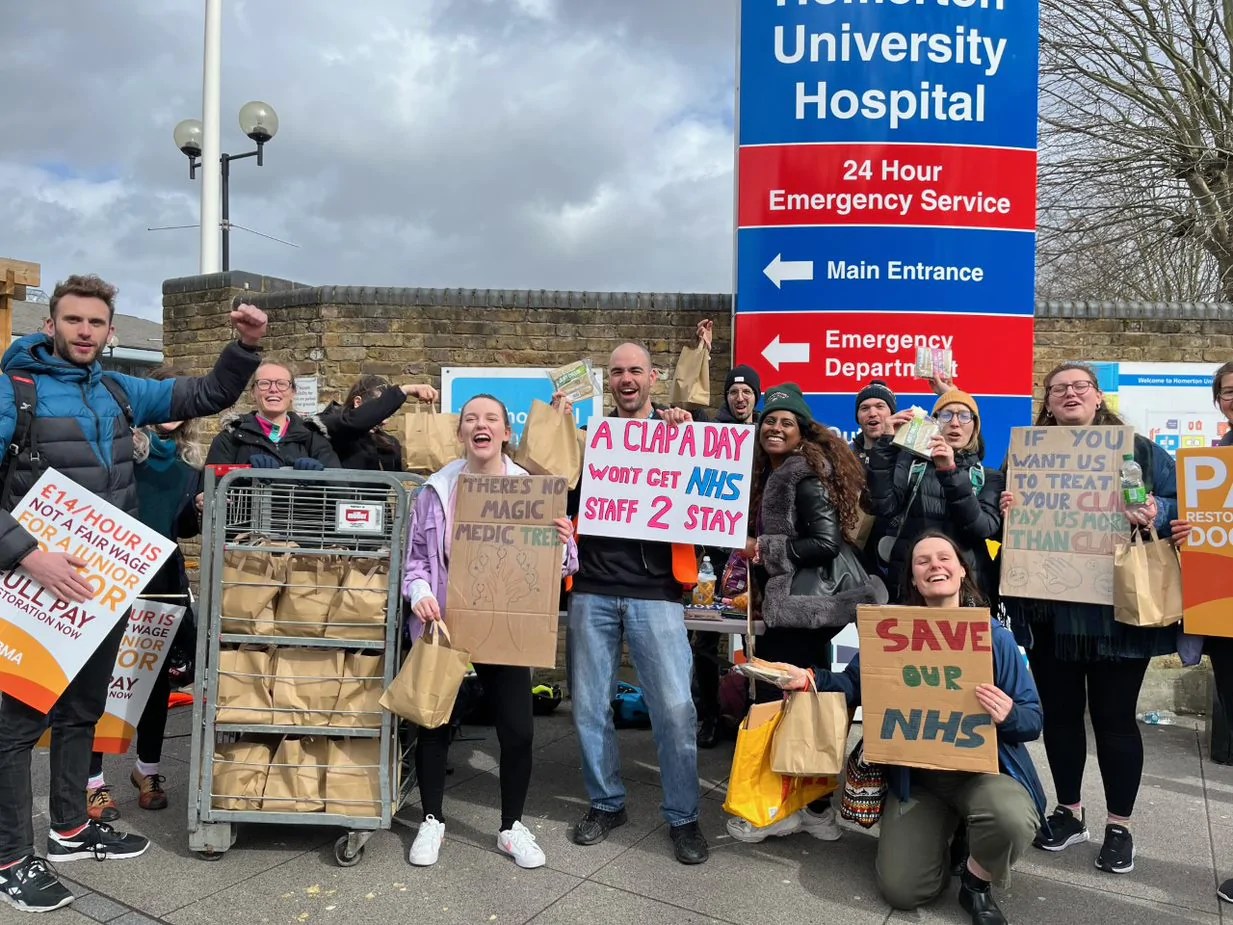 Junior doctors holding signs standing outside Homerton Hospital