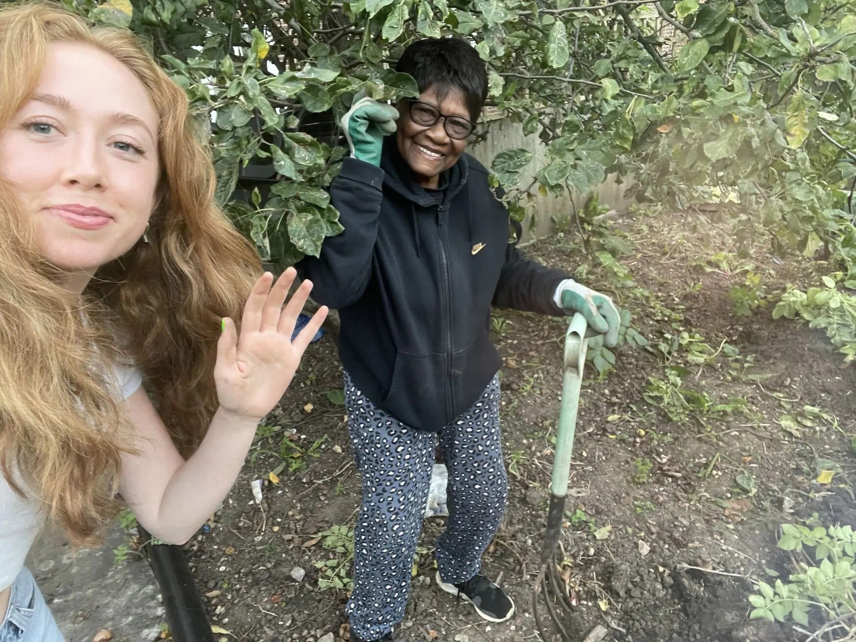 An image of a volunteer with a vulnerable adult enjoying a day on an allotment.