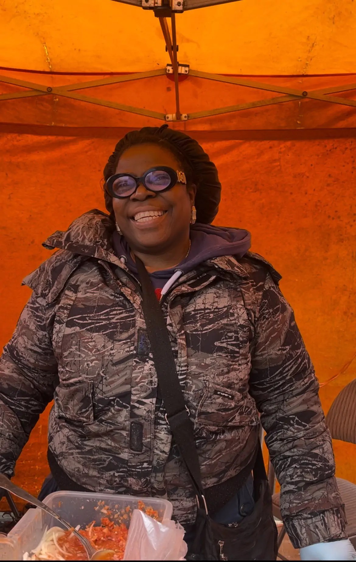 A Ridley Road Market stall holder smiling