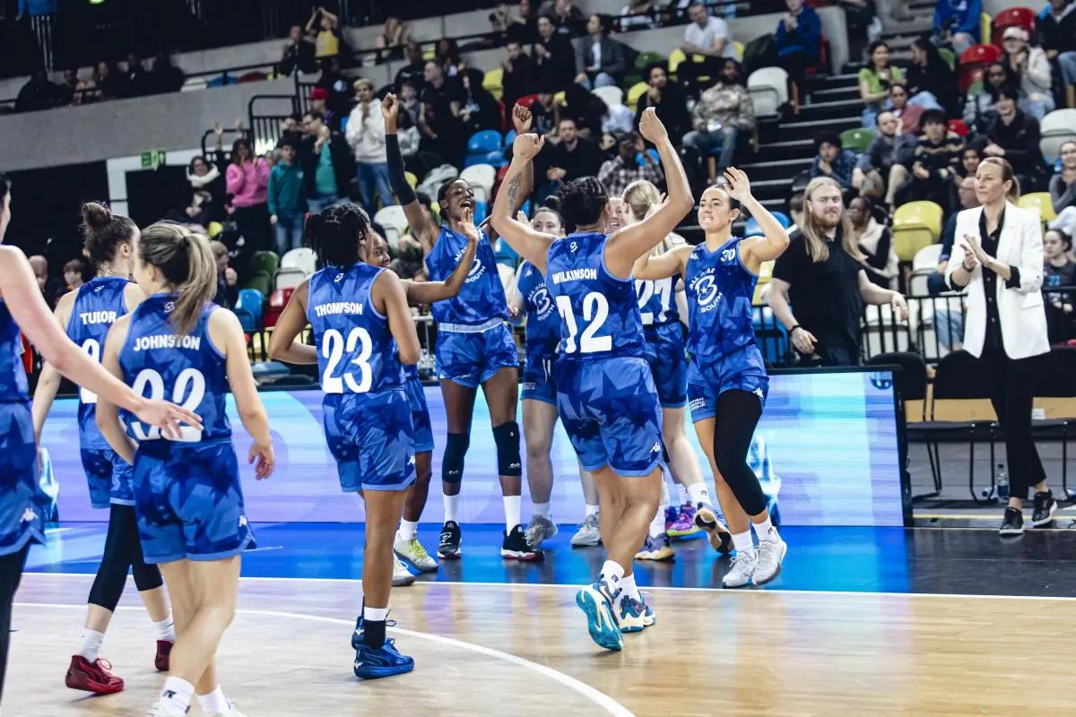 A female basketball team celebrating