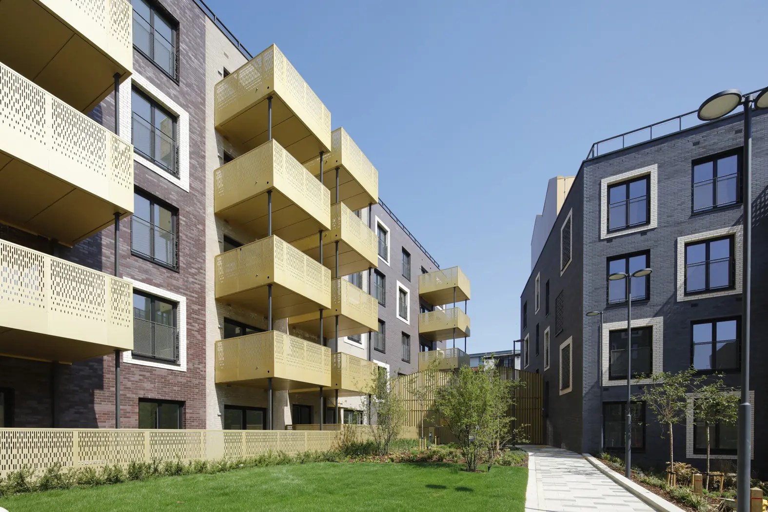 different blocks of flats in hackney over green grass.