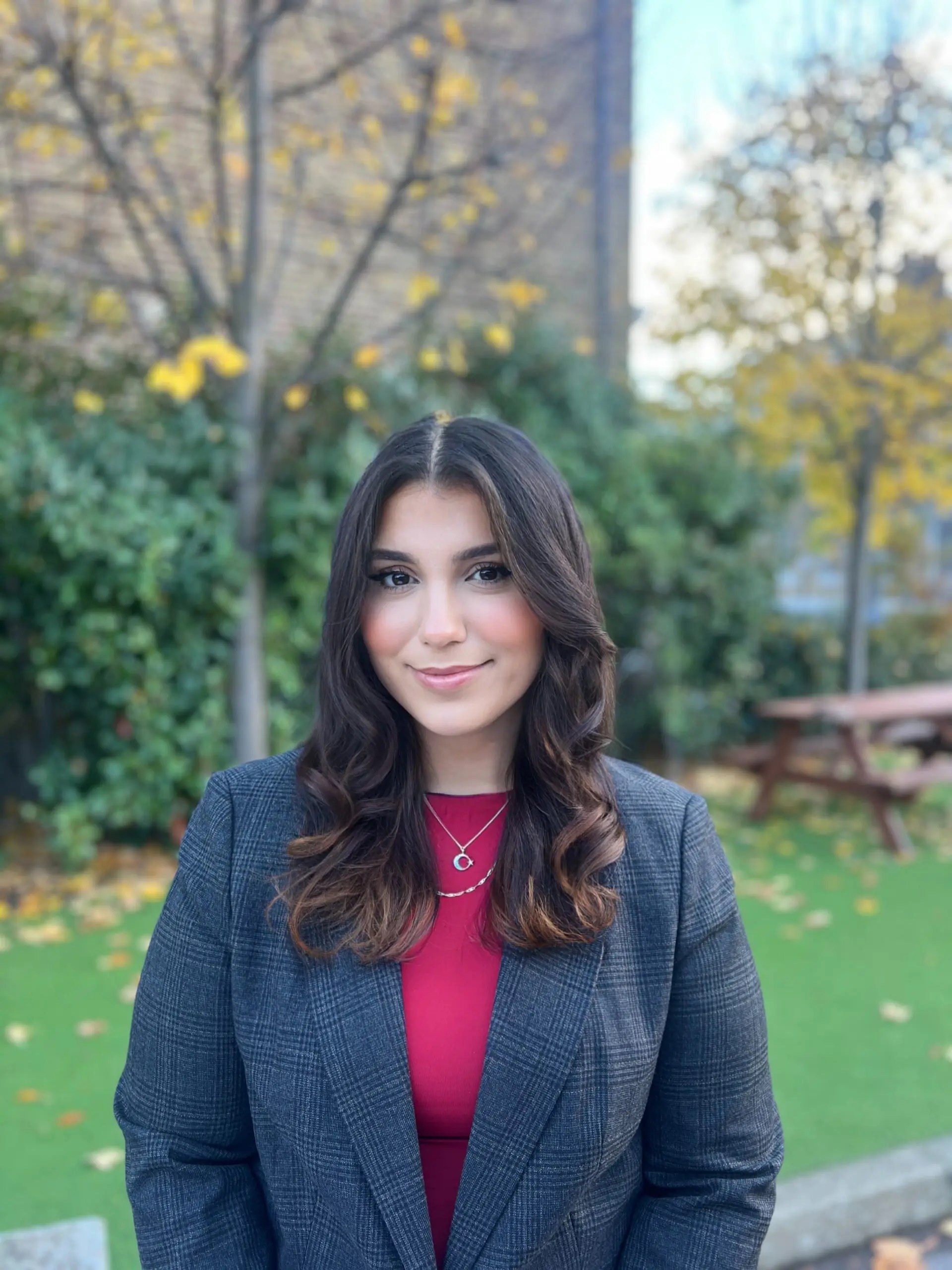Young woman outside in professional attire.