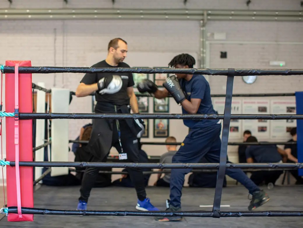 A photo of a student in the Boxing Academy, fighting in the boxing ring with their pod leader