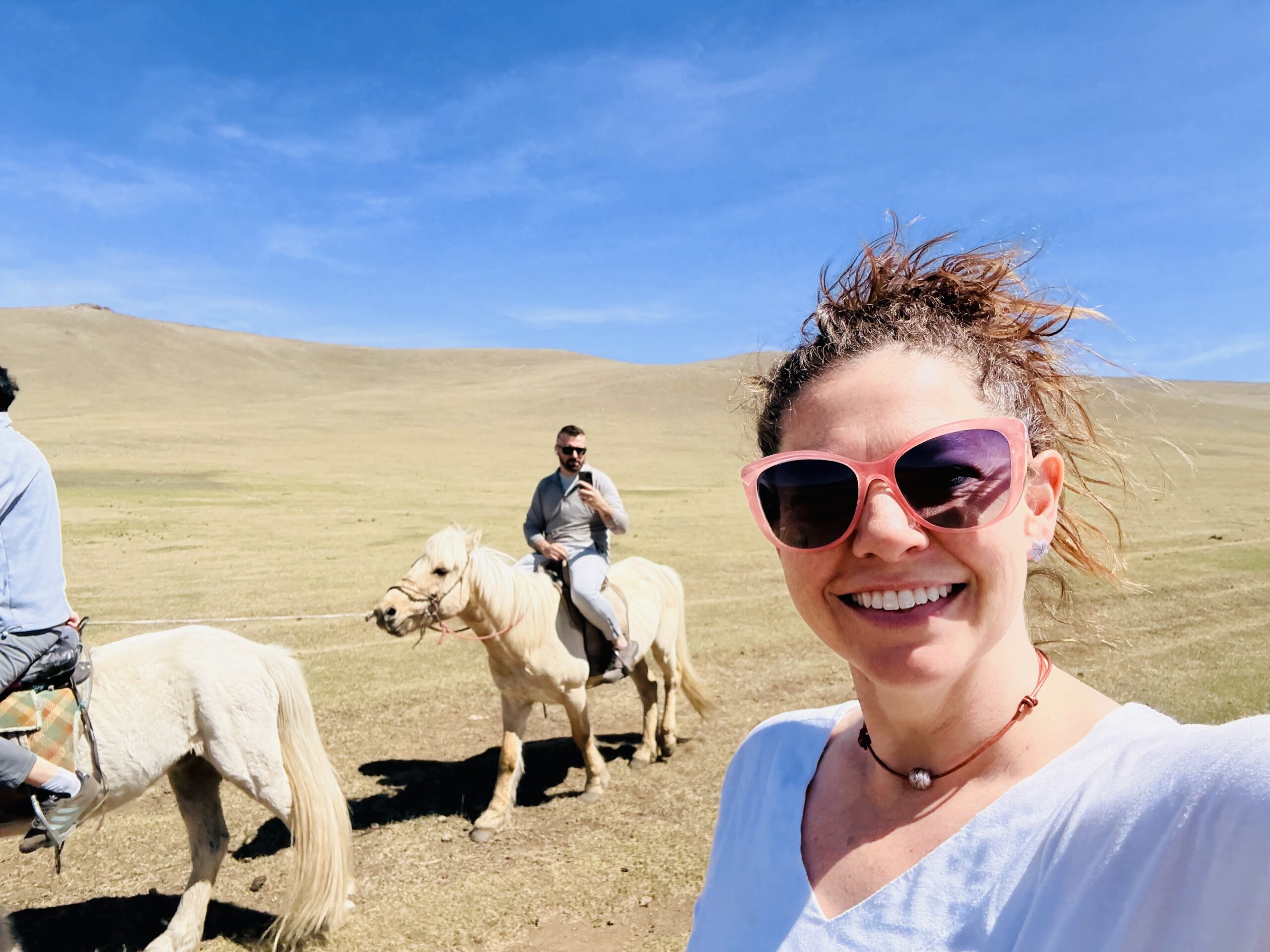 Woman and man on Mongolian horses