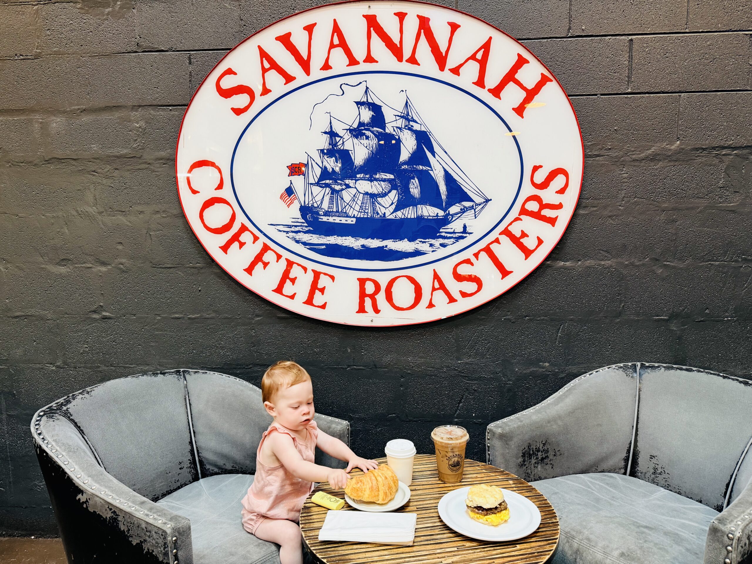 Baby having coffee and croissant