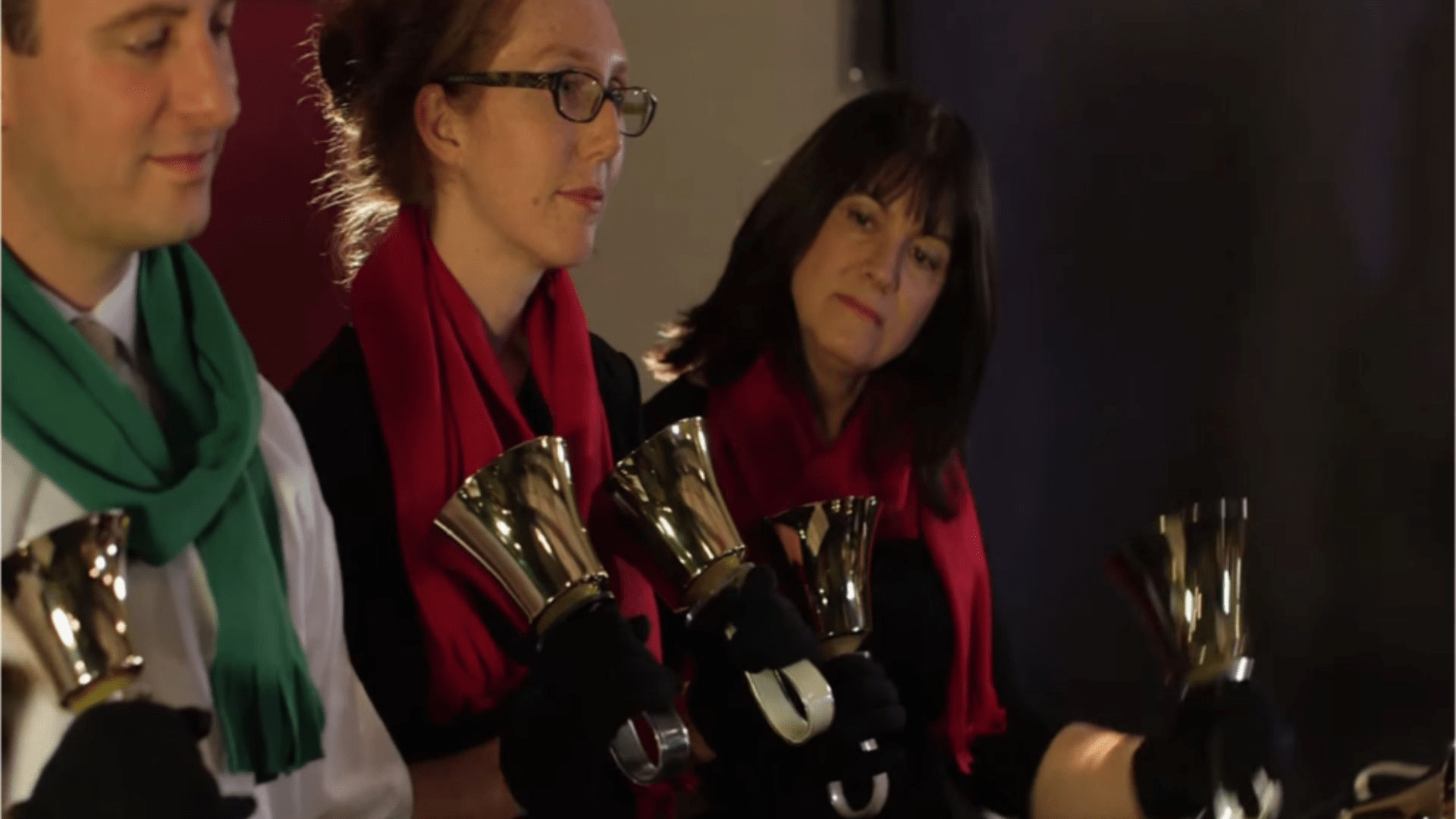 Three ringers wearing holiday scarfs