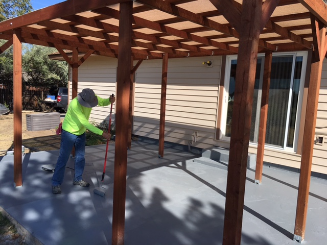 Painting a patio after covering it.