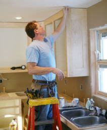 Handyman Working on Cabinets