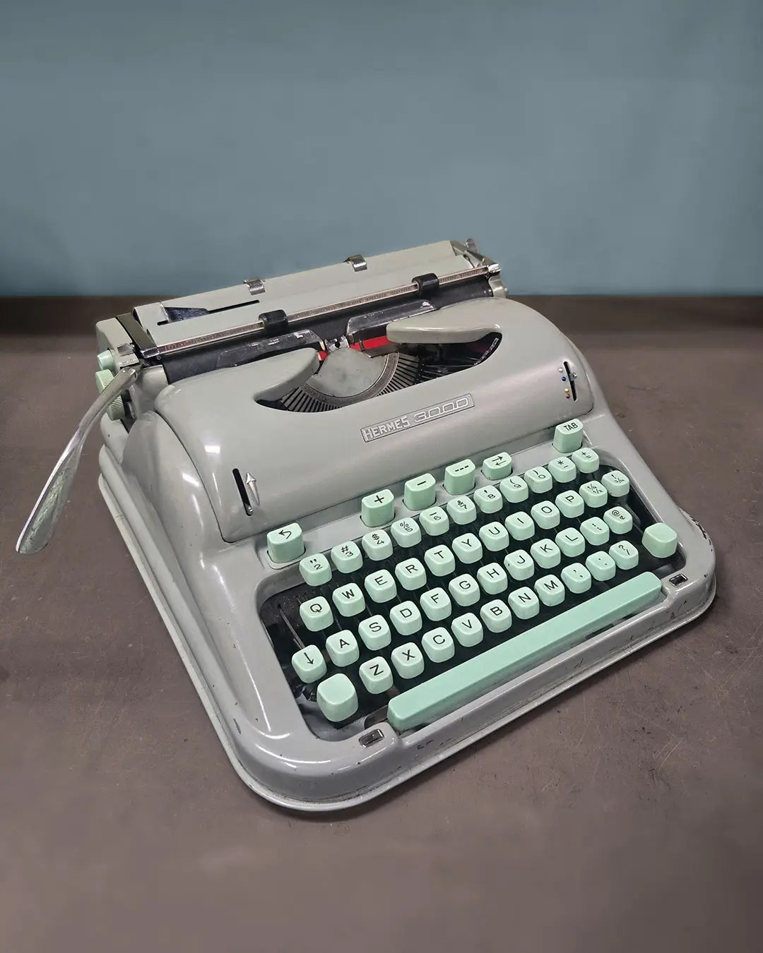 An angled view of a Hermes 3000 typeface in its classic seafoam color