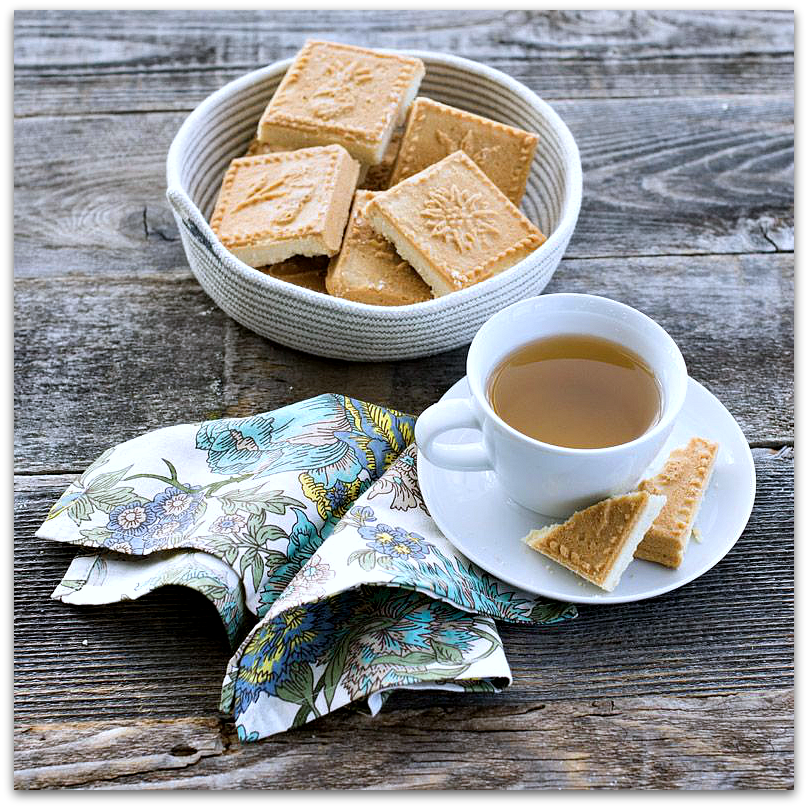 Dish of shortbread with cup of tea & napking