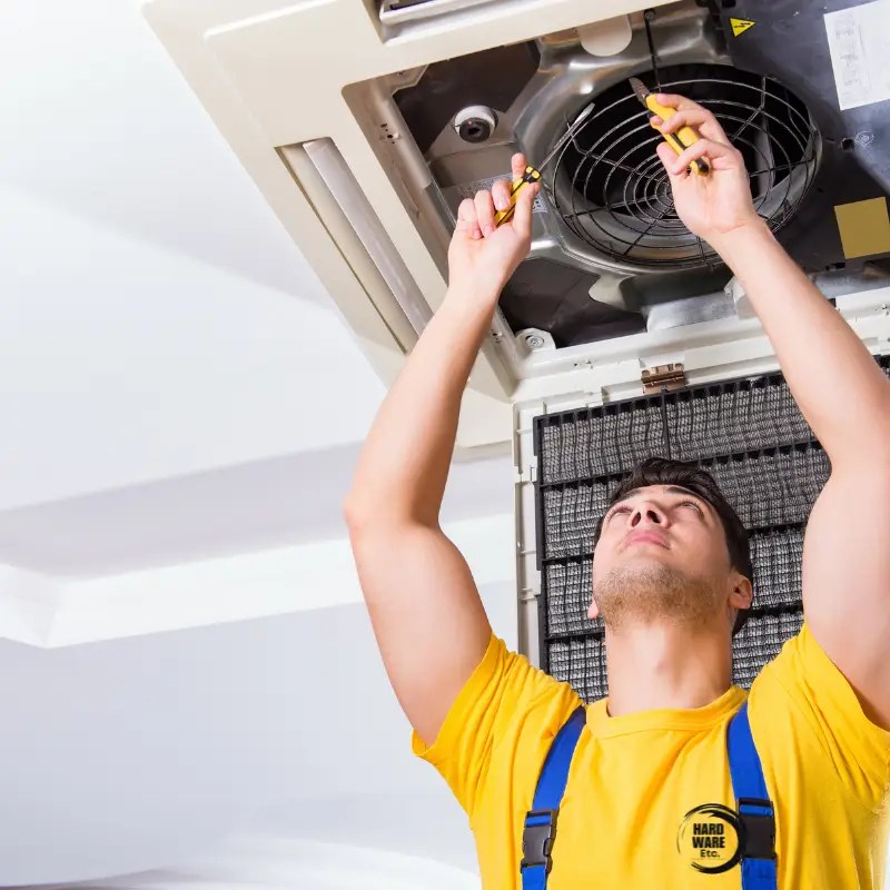 Electrician working on a fuse board, performing safe electrical repairs in a residential property in Kloof, South Africa.