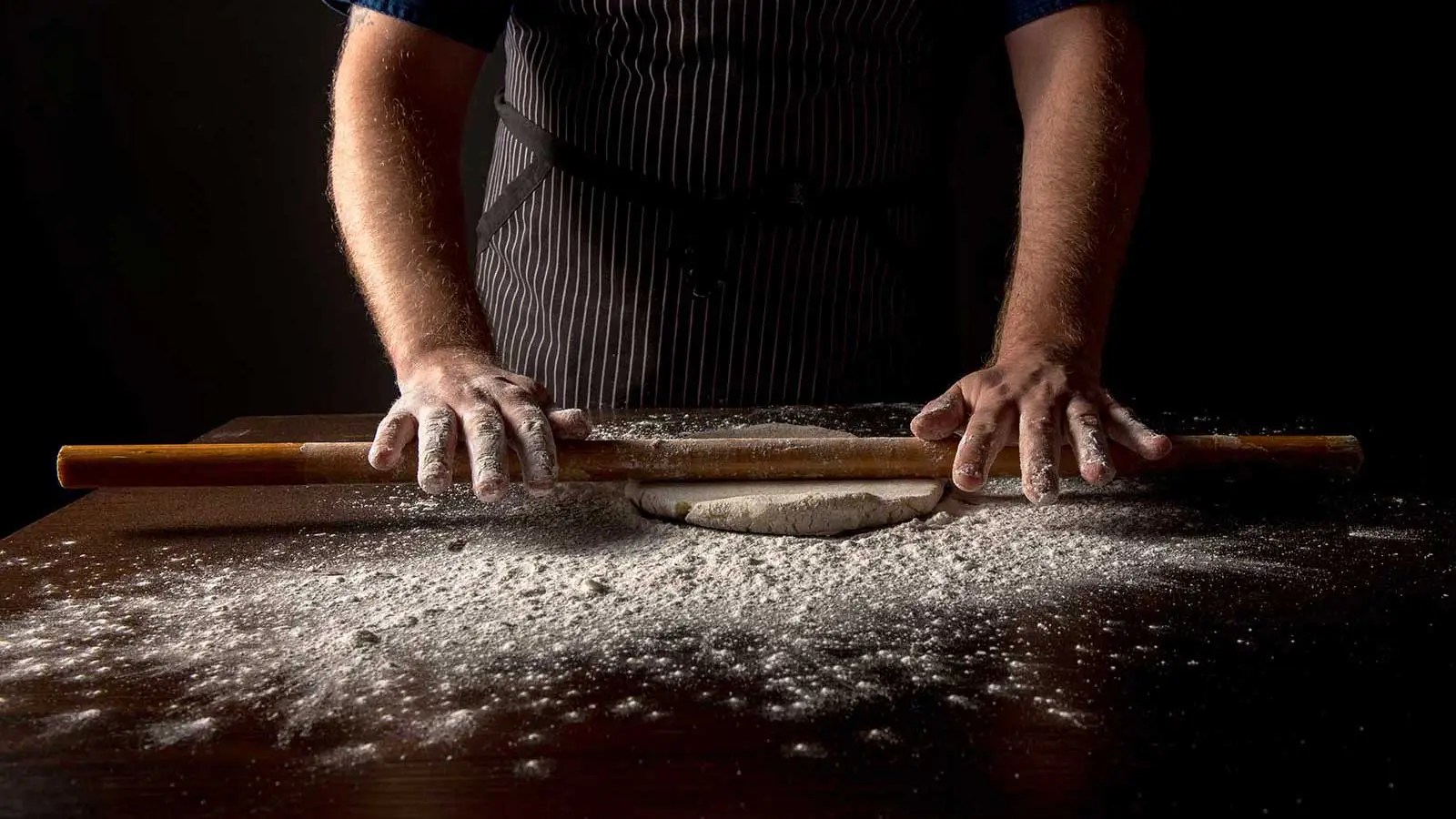 Chef Thomas rolling out dough