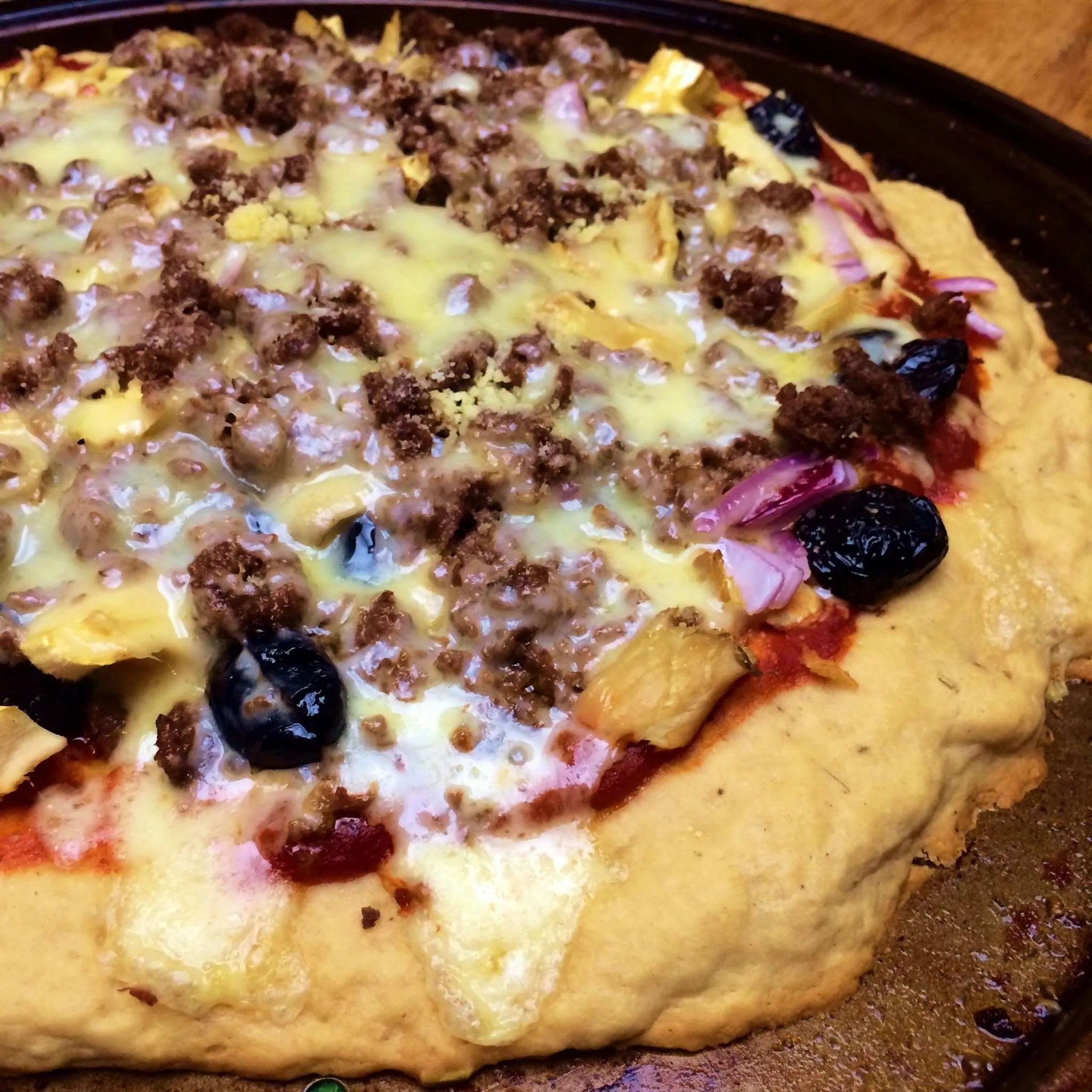 Wild Pork Sausage, Black Olive, and Mushroom Pizza with Homemade