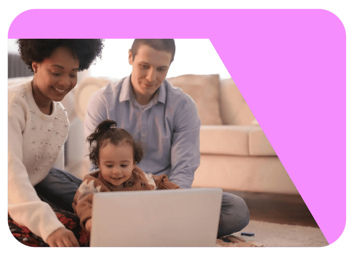 A young family sits looking at a computer. The mom is in a white sweater, smiling at her daughter who is in a brown sweater and a ponytail, and the father sits behind in a blue button down shirt.