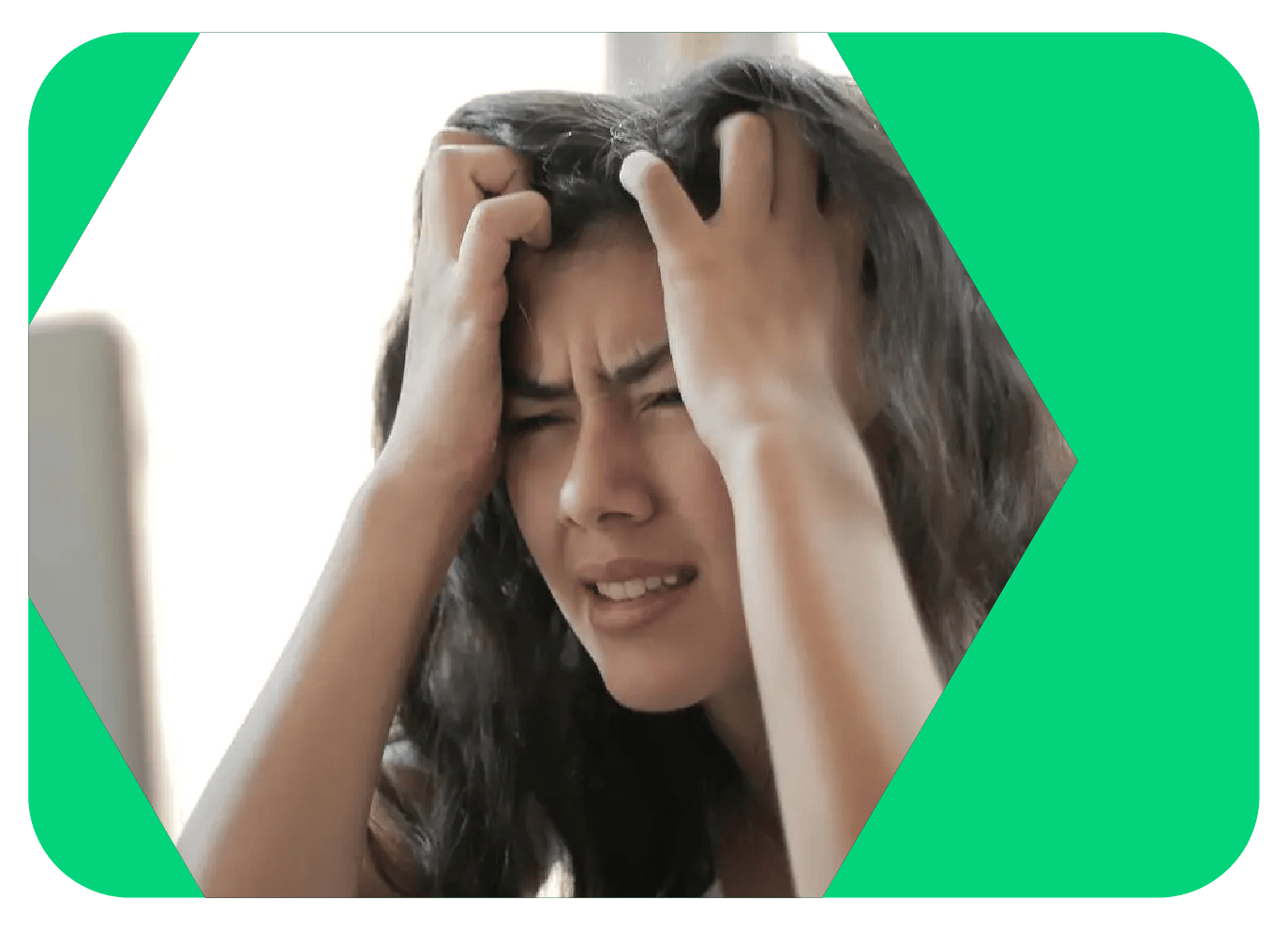 A young woman has a pained look on her face and both hands in her long brown hair because she is experiencing decision fatigue.