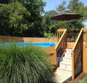 pool ground above backyard hill landscaping around pools hawk cheap swimming landscaped hiding garden ornamental grasses fun