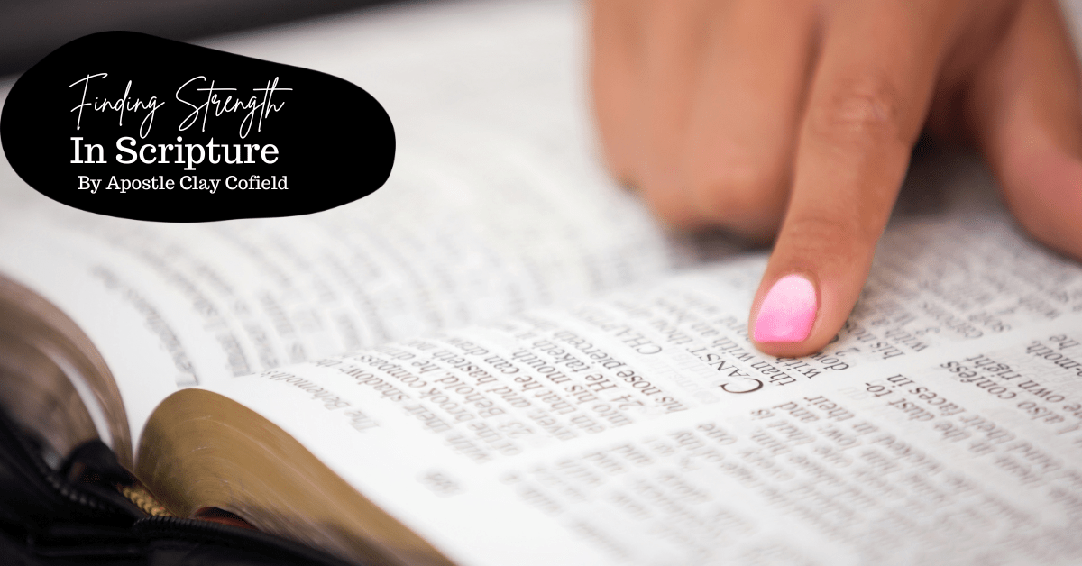 A finger with pink nail polish points to text in an open Bible beneath an Apostle Clay Cofield article title about strength in scripture.