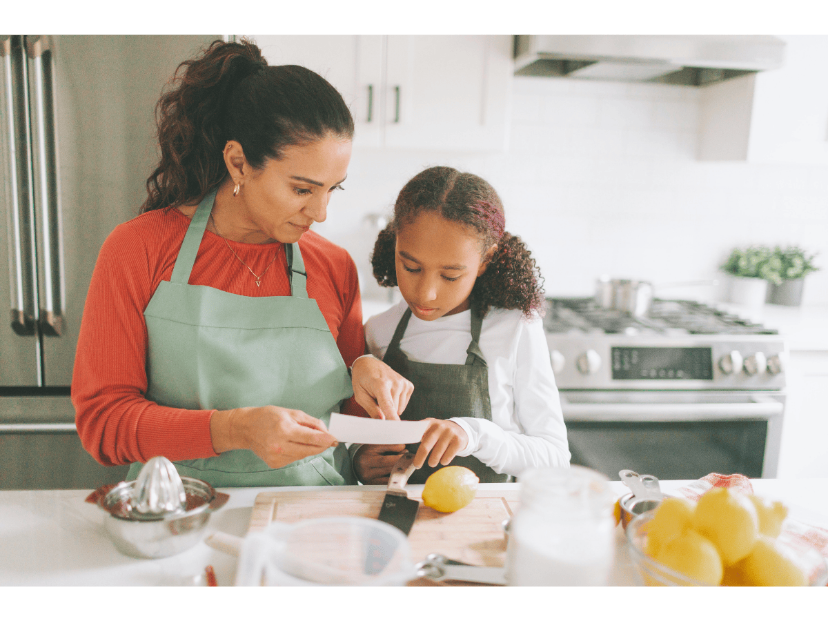 Mother and daughter learning a new recipe together in the kitchen.