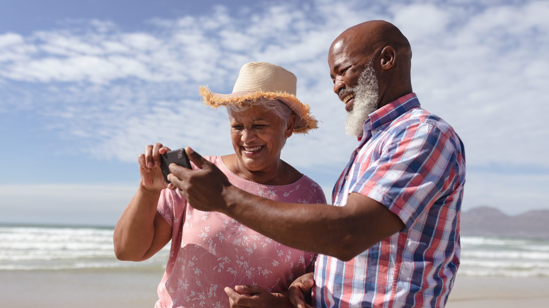 A happy couple celebrates turning 65 with Healthy Mississippi, Inc. by taking a stroll on the beach.