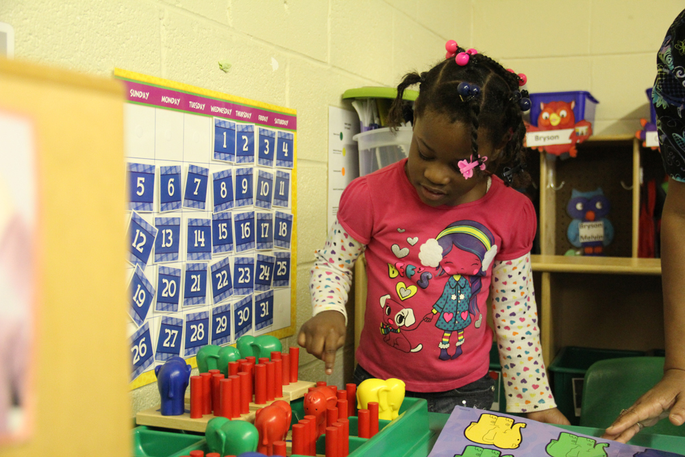 A student in Jennifer Calvert’s pre-K classroom counts colorful toys. Calvert says she will be able to buy more materials and technology with the help of state funds. (Photo: Jackie Mader)