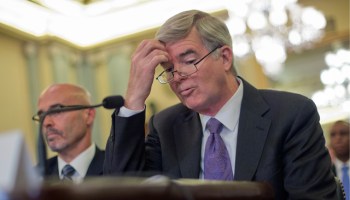 In this July 9, 2014, file photo, NCAA President Mark Emmert scratches his forehead as he testifies on Capitol Hill in Washington before the Senate Commerce, Science and Transportation hearing on the NCAA's treatment of athletes. At left is Dr. Richard M. Southall, Associate Professor, Department of Sport and Entertainment Management. (AP Photo/Pablo Martinez Monsivais, File)