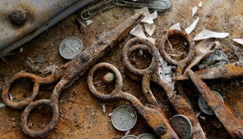 Rusted scissors, coins and other debris sit on the floor of an elementary school in the Lakeview neighborhood of New Orleans, La. File Photo. (AP Photo/Eric Gay)