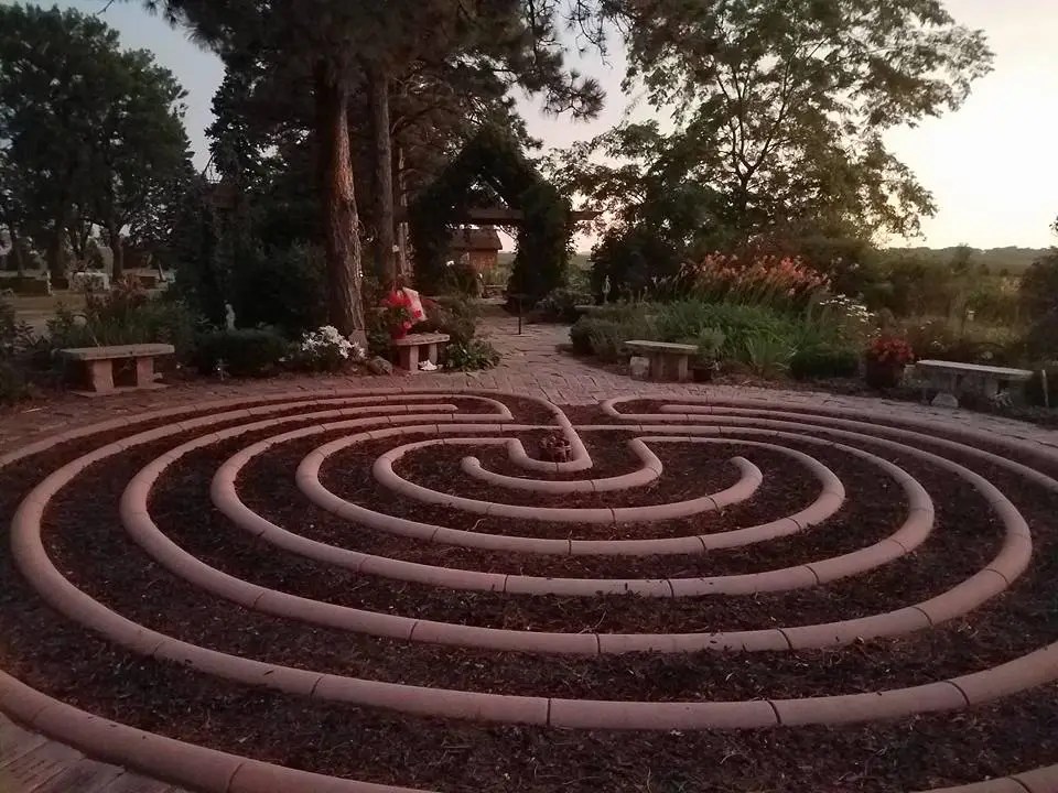 Image of bricks laid in circular rings on mulch.