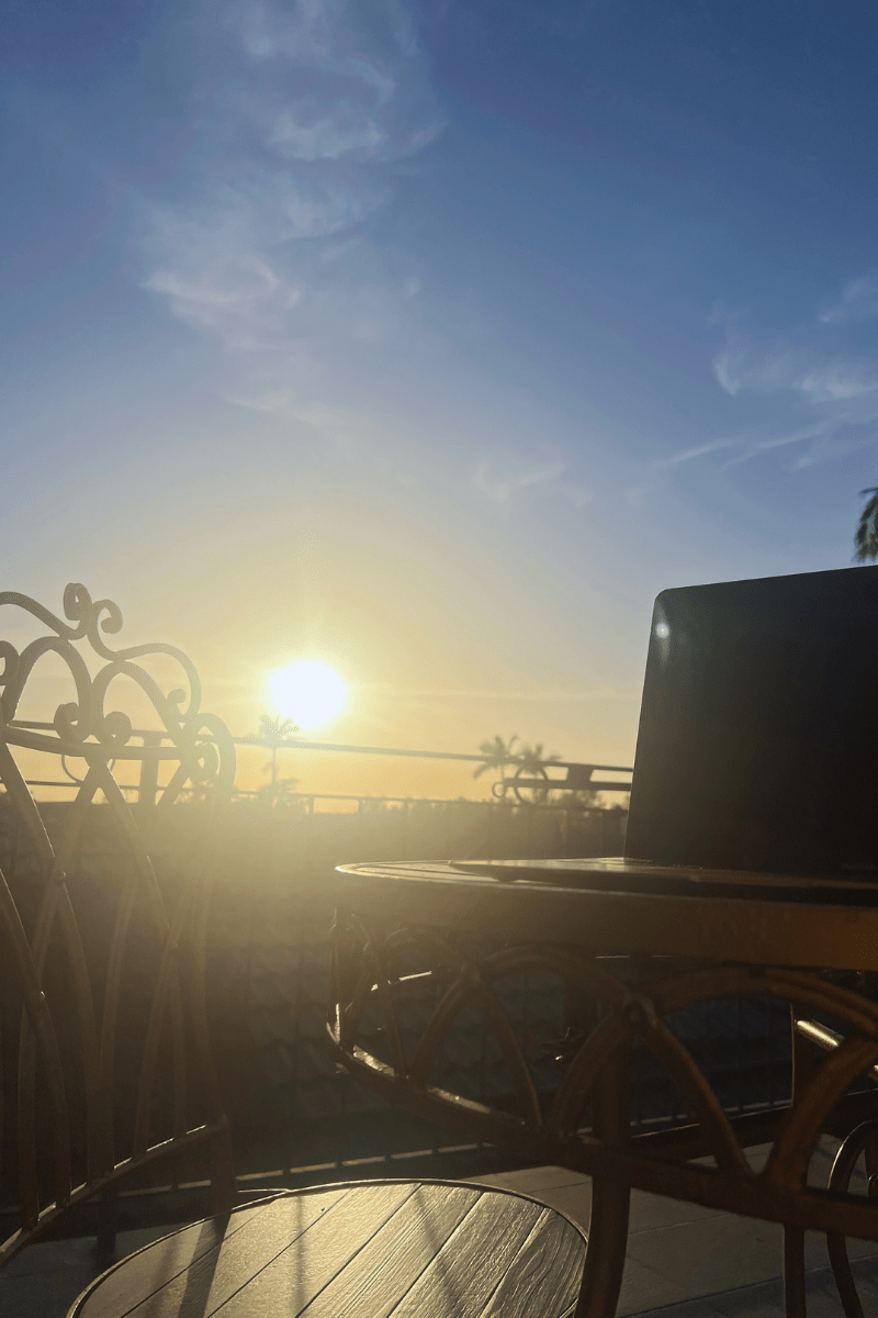 sunrise, laptop, working, self-care, outdoor patio, vintage bistro setting