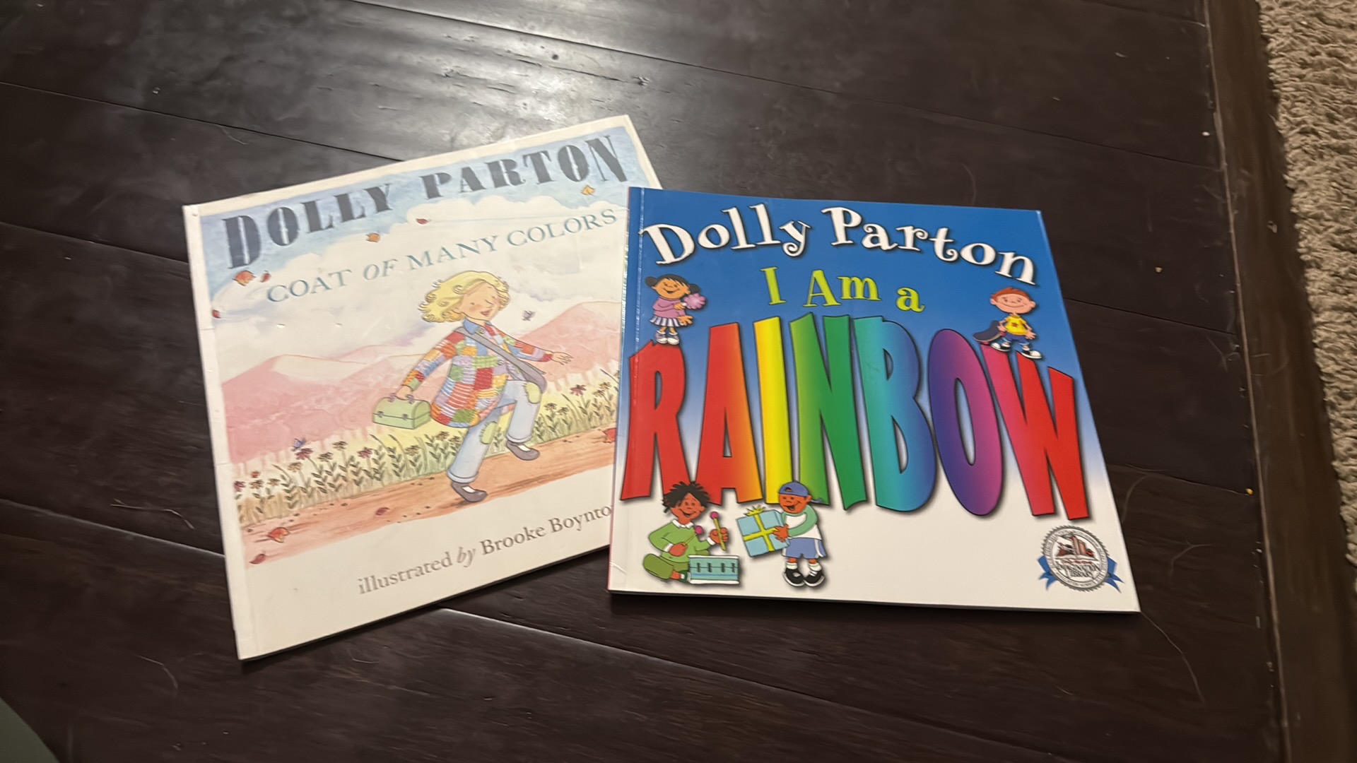 photo of two books by Dolly Parton "Coat of Many Colors" and "I am a Rainbow"