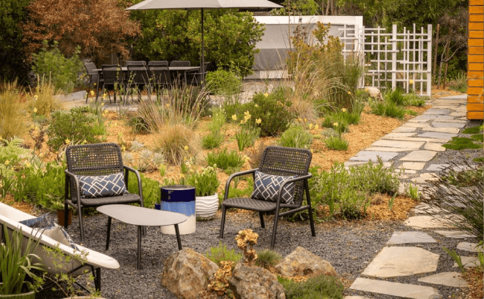 2 chairs in a natural backyard next to an adu