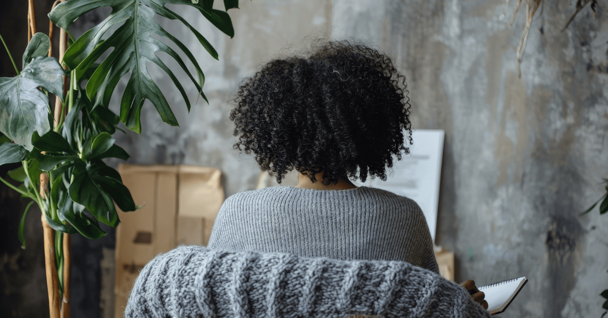 woman with notebook learning to stop being busy and start building