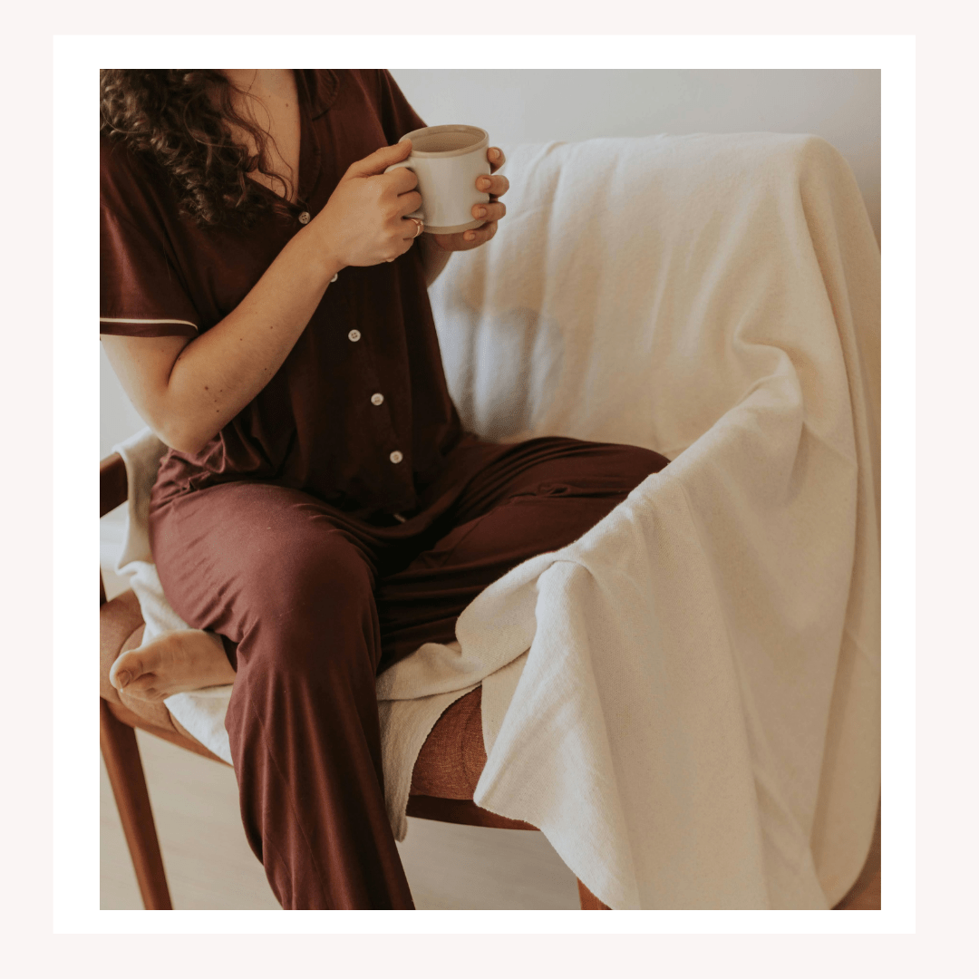 Woman relaxing in pajamas with coffee in the morning