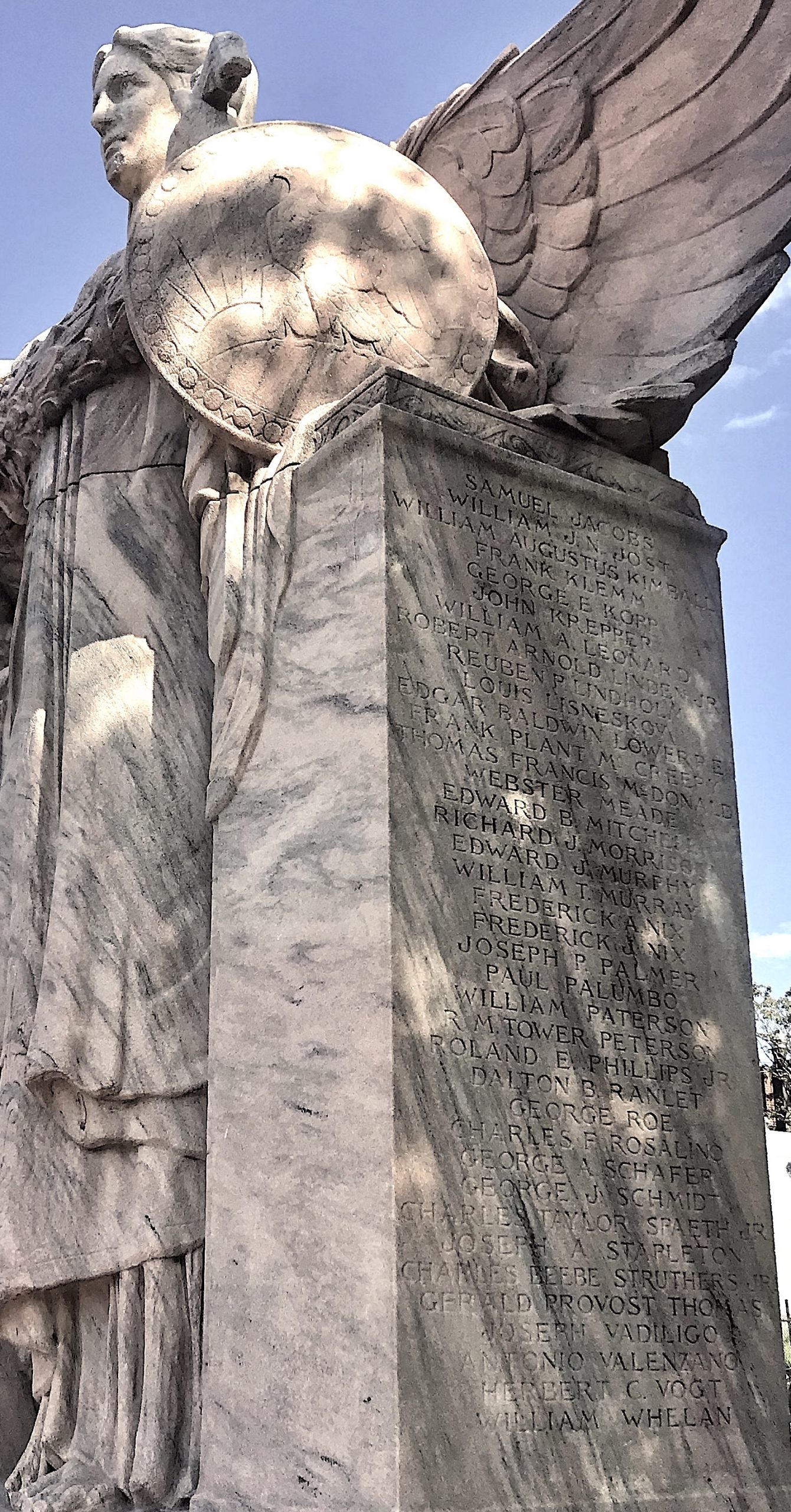 Liberty's wings and shield protect the names listed below them
