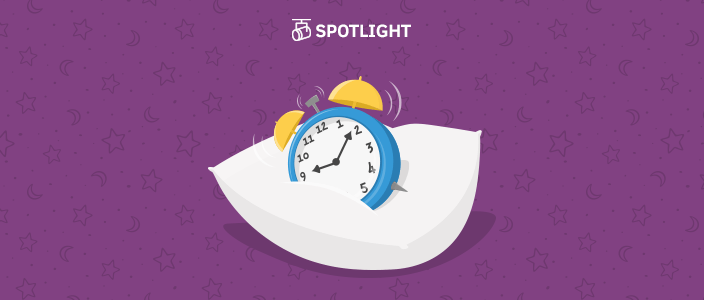 Alarm clock going off on a pillow