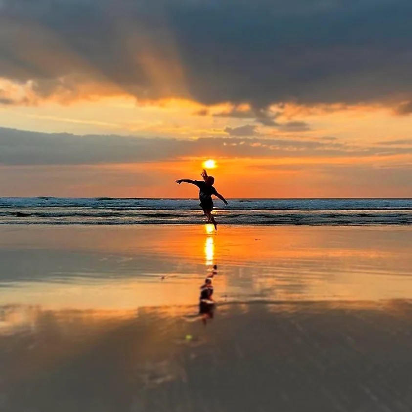 Sustainable Camping and Bell Tents Dancing at sunset on the beach