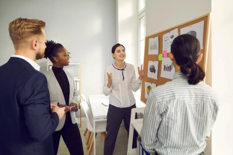 work group in discussion near a presentation board