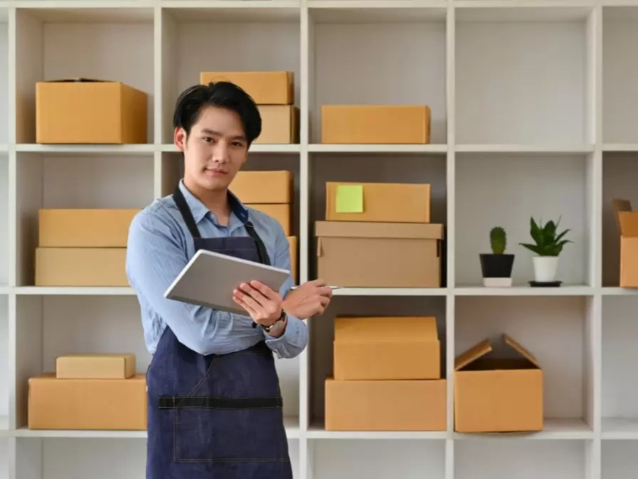 man standing with tablet in hand completing standard operating procedures