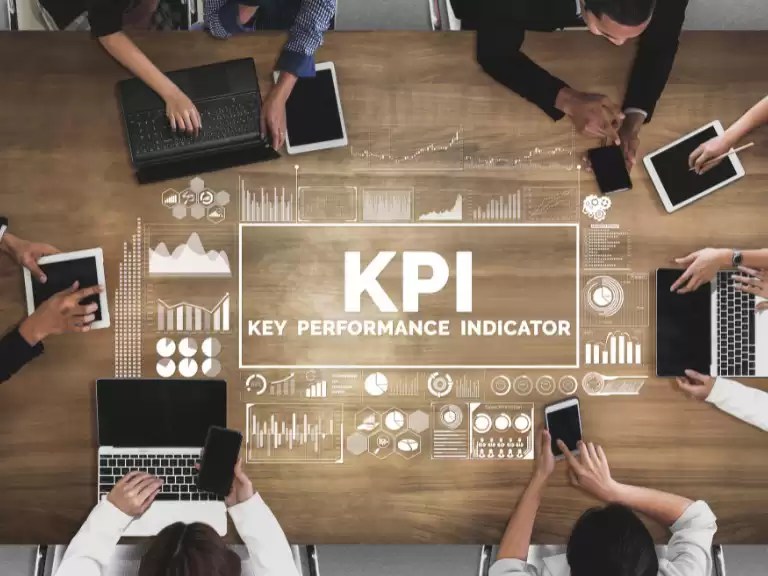 people working around a table discussing key performance indicators